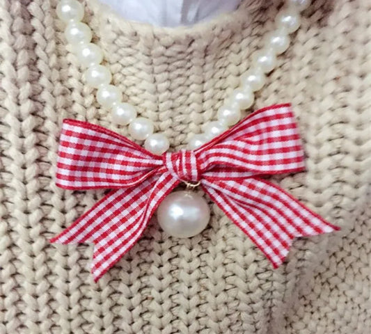 Imitation Pearl Necklace with red and white plaid bow.